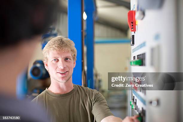 Man At Control Panel In Olive Processing Plant, Foto de stock
