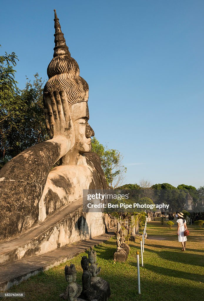 Woman with large buddha statue, Xieng Khu, Vientiane, Laos