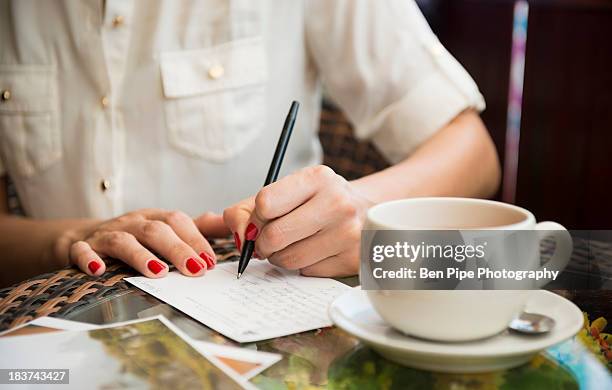 woman writing postcard in cafe - postcard tea bildbanksfoton och bilder