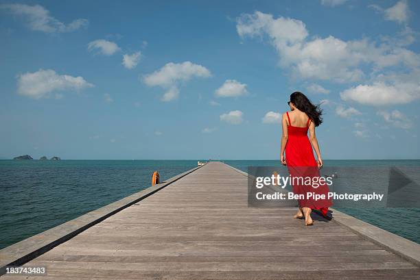 woman on pier, taling ngam beach, ko samui, thailand - rotes kleid stock-fotos und bilder