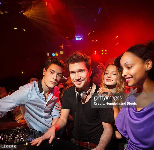 disc jockey surrounded by group of people - surrounding ストックフォトと画像