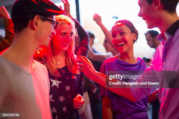 four young adults laughing at party - party in munich stock pictures, royalty-free photos & images