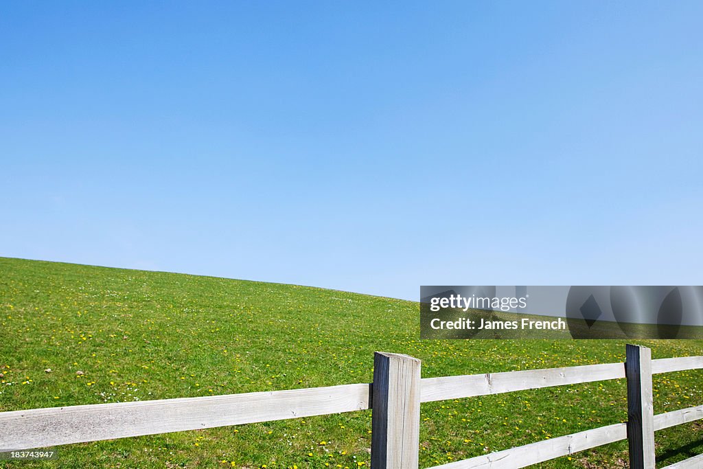 Wooden fence on plain landscape