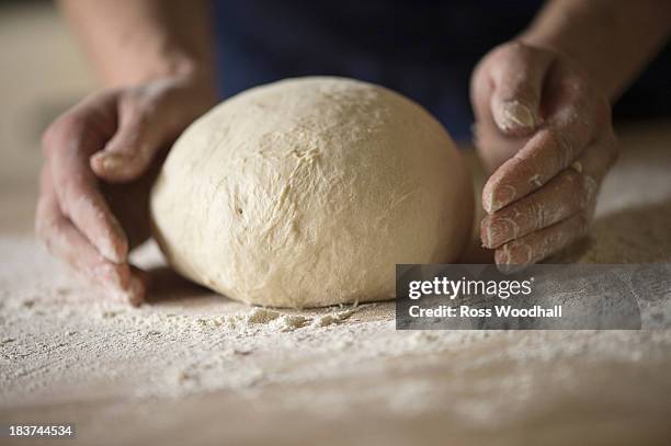 close up of hands shaping bread dough - action cooking stock pictures, royalty-free photos & images