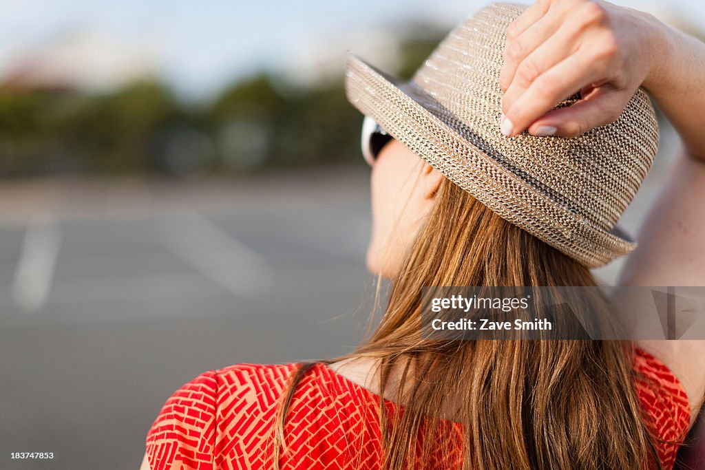 Mature woman wearing sunhat, rear view