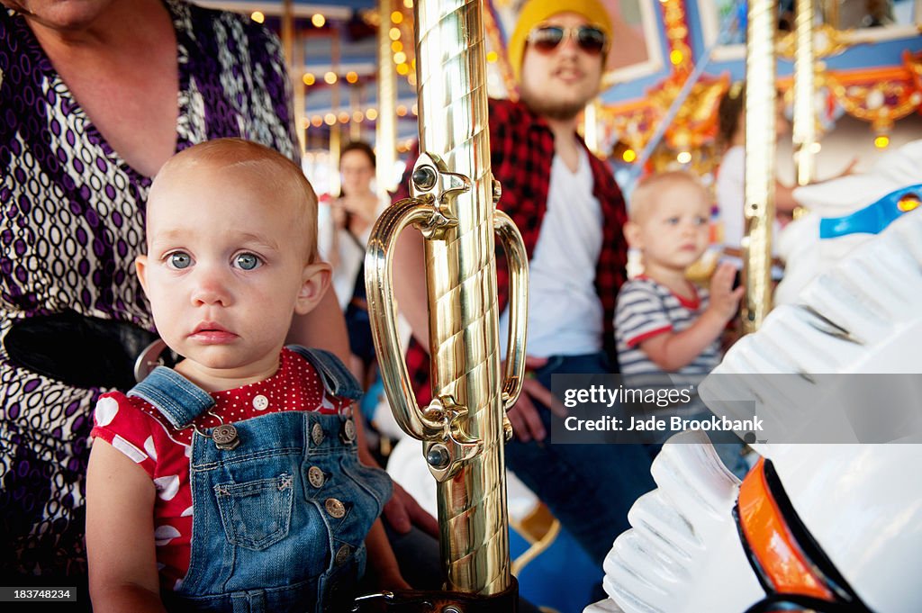 Family with two children on carousel