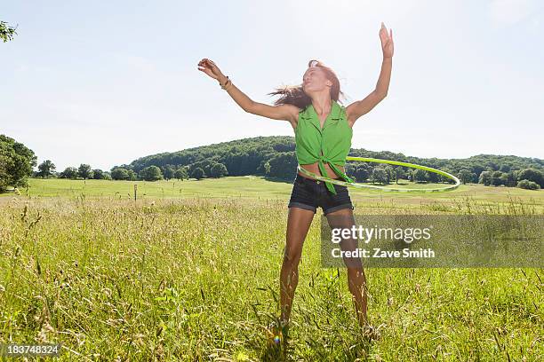 young woman with plastic hoop - gymnastikreifen stock-fotos und bilder