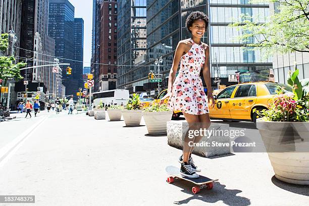 woman skateboarding - high street fotografías e imágenes de stock