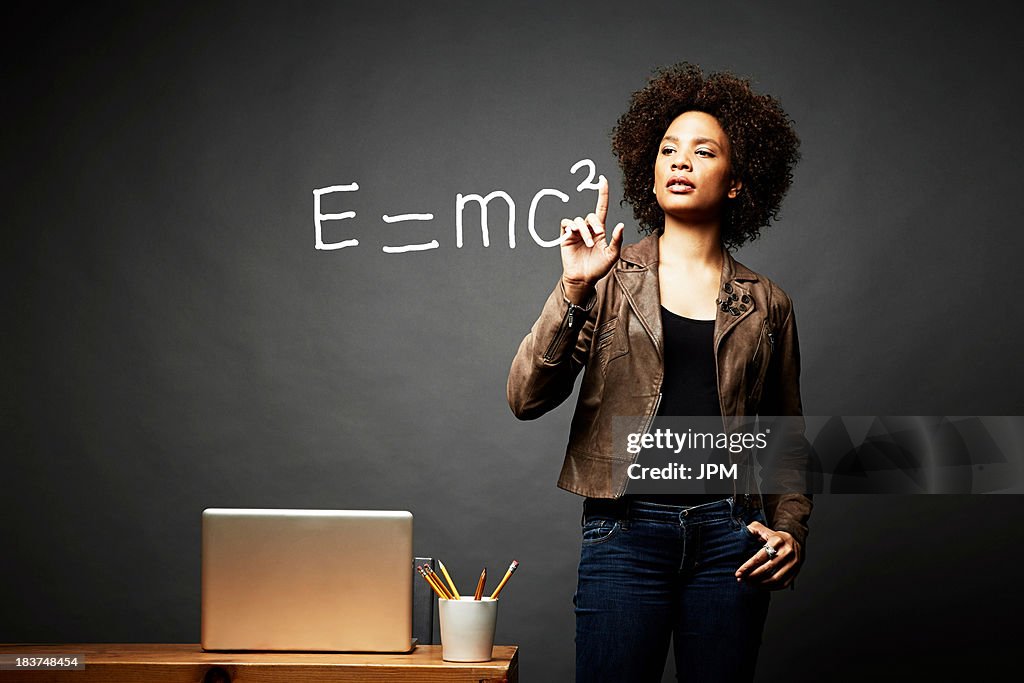 Woman solving mathematical equation