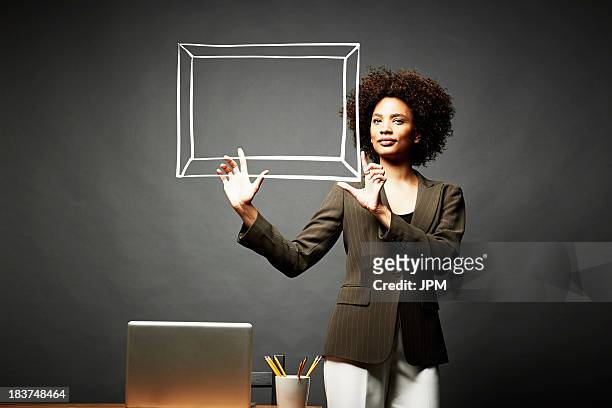 woman holding up a picture frame - holding up line stock pictures, royalty-free photos & images