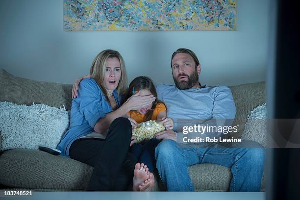 parents and child watching horror movie - scary movie 3 stock pictures, royalty-free photos & images