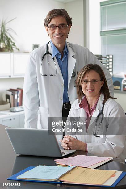 two doctors looking at camera - cadalpe stock pictures, royalty-free photos & images