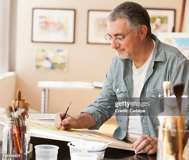 man painting with watercolors - cadalpe stock pictures, royalty-free photos & images