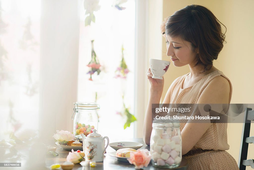 Woman looking down at tea cup