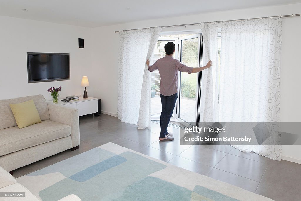 Man looking out of glass door