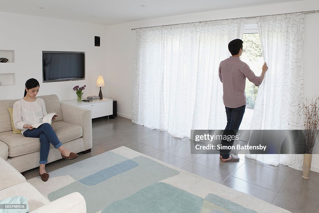 Husband and wife relaxing in living room