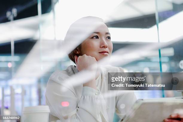 woman in cafe looking into distance - transparent blouse stock pictures, royalty-free photos & images