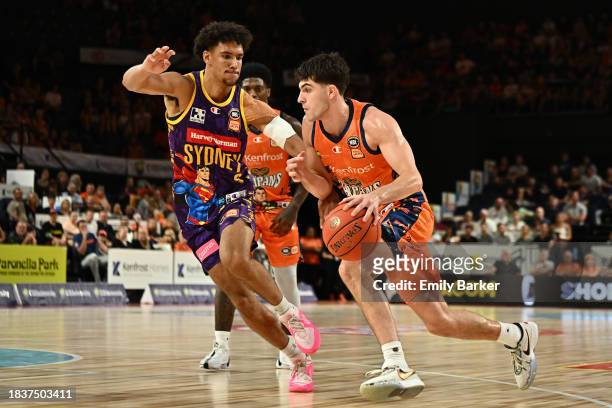 Taran Armstrong of the Taipans drives up court under pressure from Jaylin Galloway of the Kings during the round 10 NBL match between Cairns Taipans...