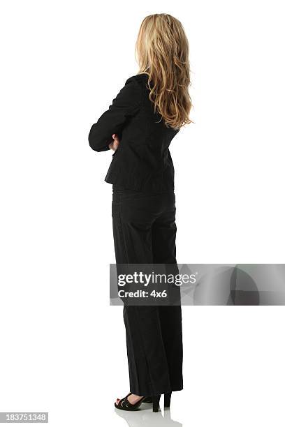 businesswoman standing with arms crossed - blonde hair rear white background stock pictures, royalty-free photos & images