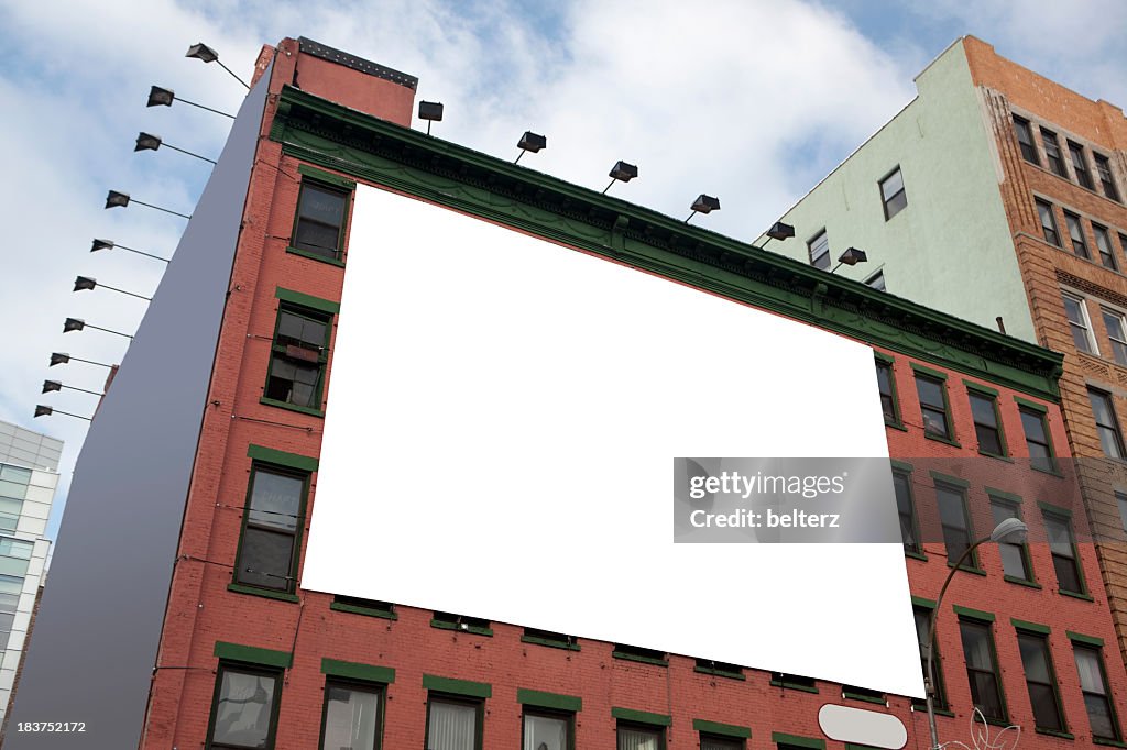 Blank white billboard on the side of a tall building