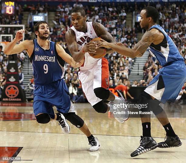 Toronto Raptors point guard Dwight Buycks is called for travelling while trying to cut between Ricky Rubio and Lorenzo Brown as the Toronto Raptors...