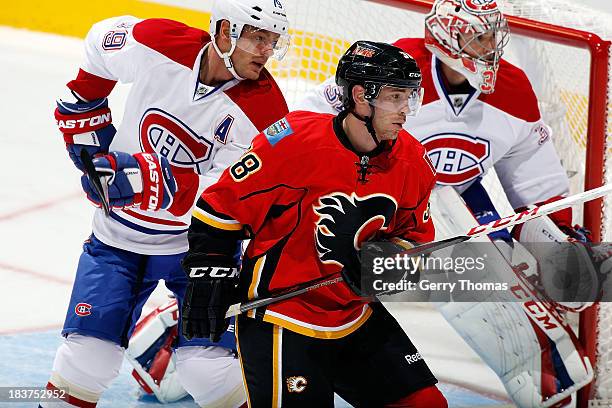 Ben Street of the Calgary Flames skates against Andrei Markov and Carey Price of the Montreal Canadiens at Scotiabank Saddledome on October 9, 2013...