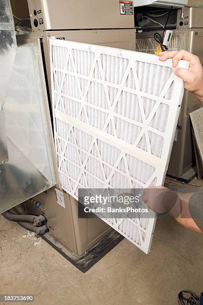 male hands change large pleated furnace air filter - air duct repair stock pictures, royalty-free photos & images