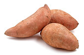 Close-up of three Raw sweet potatoes