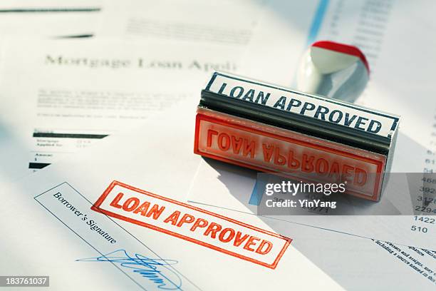 “loan approved” approval red rubber stamp approving mortgage application document - commercial mortgage stock pictures, royalty-free photos & images