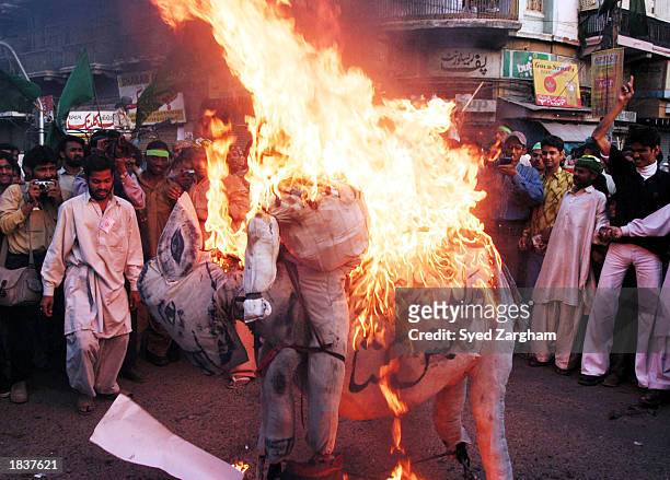Anti-U.S. Protesters burn an effigy of U.S. President George W. Bush at a protest rally March 9, 2003 in Karachi, Pakistan. The protesters oppose a...