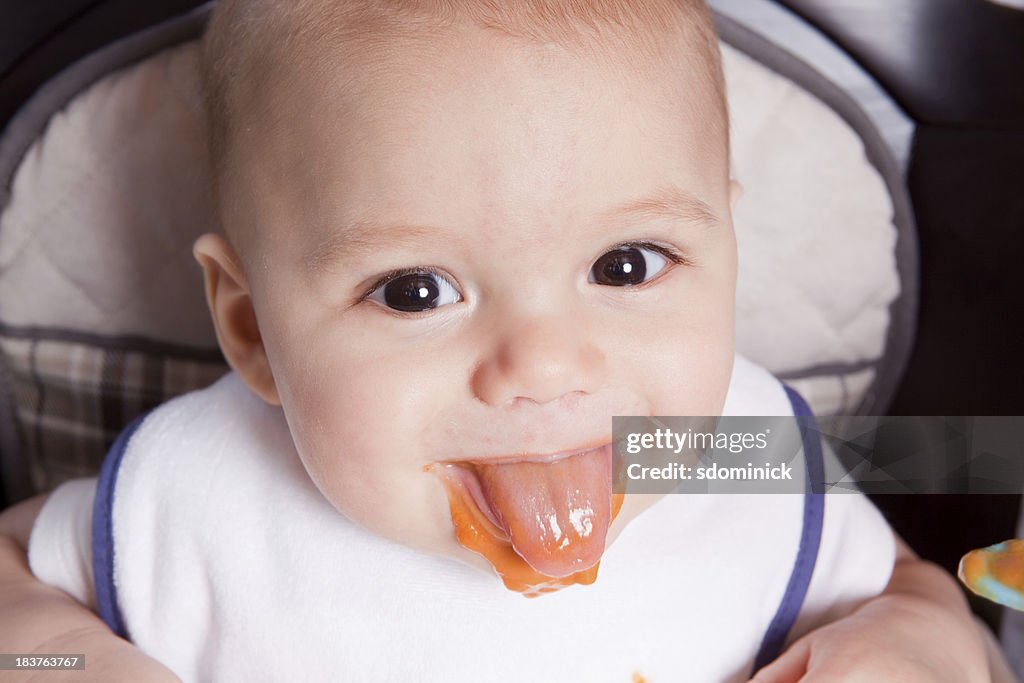 Baby Boy Sticking Tongue Out With Food