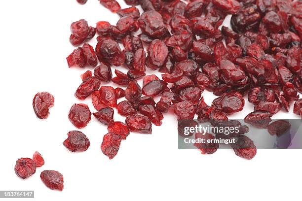 dry cranberries over white background - dried food stock pictures, royalty-free photos & images