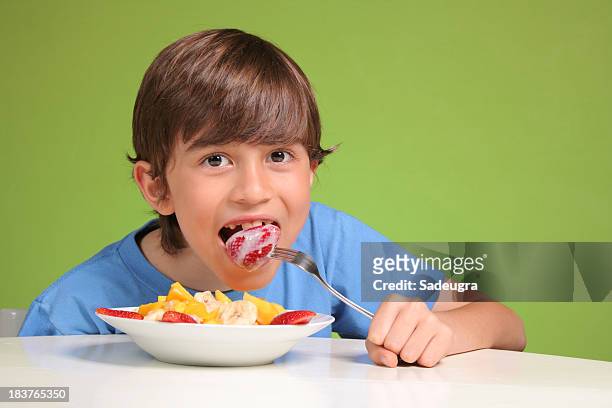 ragazzo mangiando frutta - condensed milk foto e immagini stock