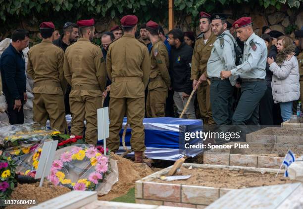 Soldiers, family and members of the public attend the funeral for Sgt. Amit Bonzel at Mount Herzl cemetery on December 07, 2023 in Jerusalem. The...