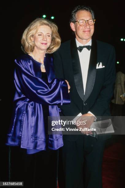 American actress Blythe Danner, wearing a blue jacket, and her husband, American film director and producer Bruce Paltrow, who wears a tuxedo and bow...