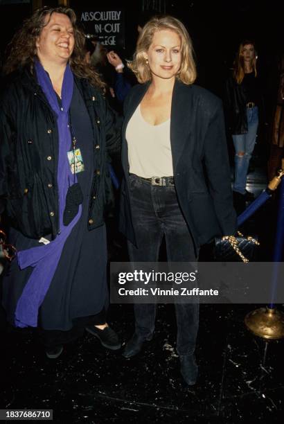 American actress Beverly D'Angelo, wearing a black jacket over a white scooped neck top and black jeans, United States, 1993.