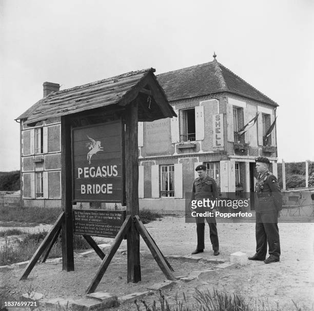 From left, Major John Howard and Captain David Wood of the 6th Airborne Division of the British Army stand beside the Pegasus Bridge over the Caen...