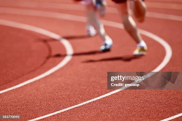 two runners on a track in running shoes racing - track stockfoto's en -beelden