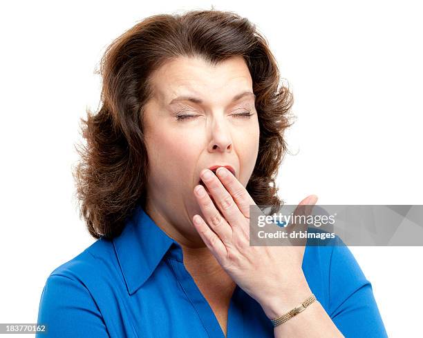 yawning woman covering mouth - yawning woman stockfoto's en -beelden