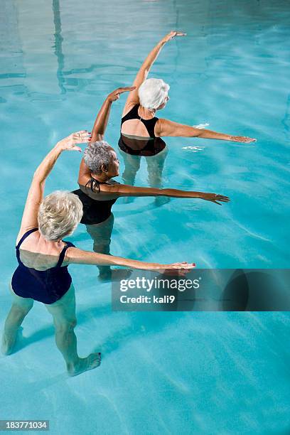 multiracial senior women in water aerobics class - aquarobics stockfoto's en -beelden