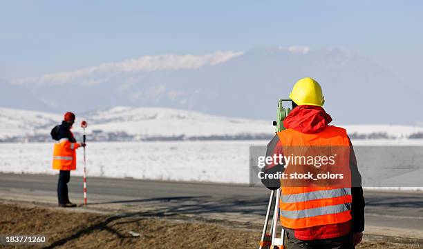 land surveyors - looking through an object stock pictures, royalty-free photos & images