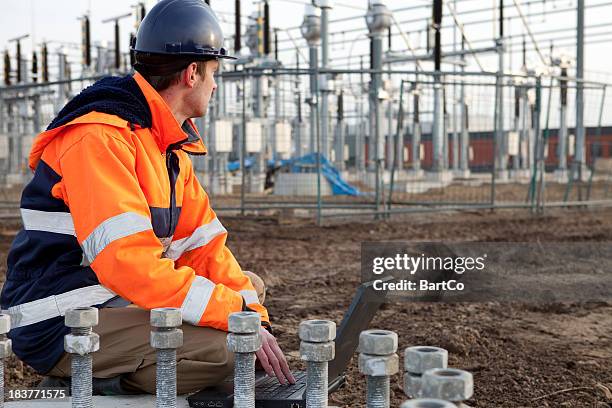 construction worker is planning to build a power station. - hoogspanningstransformator stockfoto's en -beelden