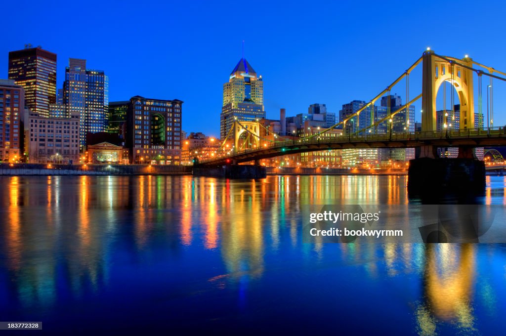 Bridge over River in Pittsburgh at night with city view