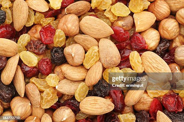 mixed nuts and dry fruits background - trail mix stock pictures, royalty-free photos & images