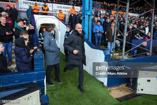 Pep Guardiola manager of Manchester City runs out of the players tunnel prior to the Premier League match between Luton Town and Manchester City at...