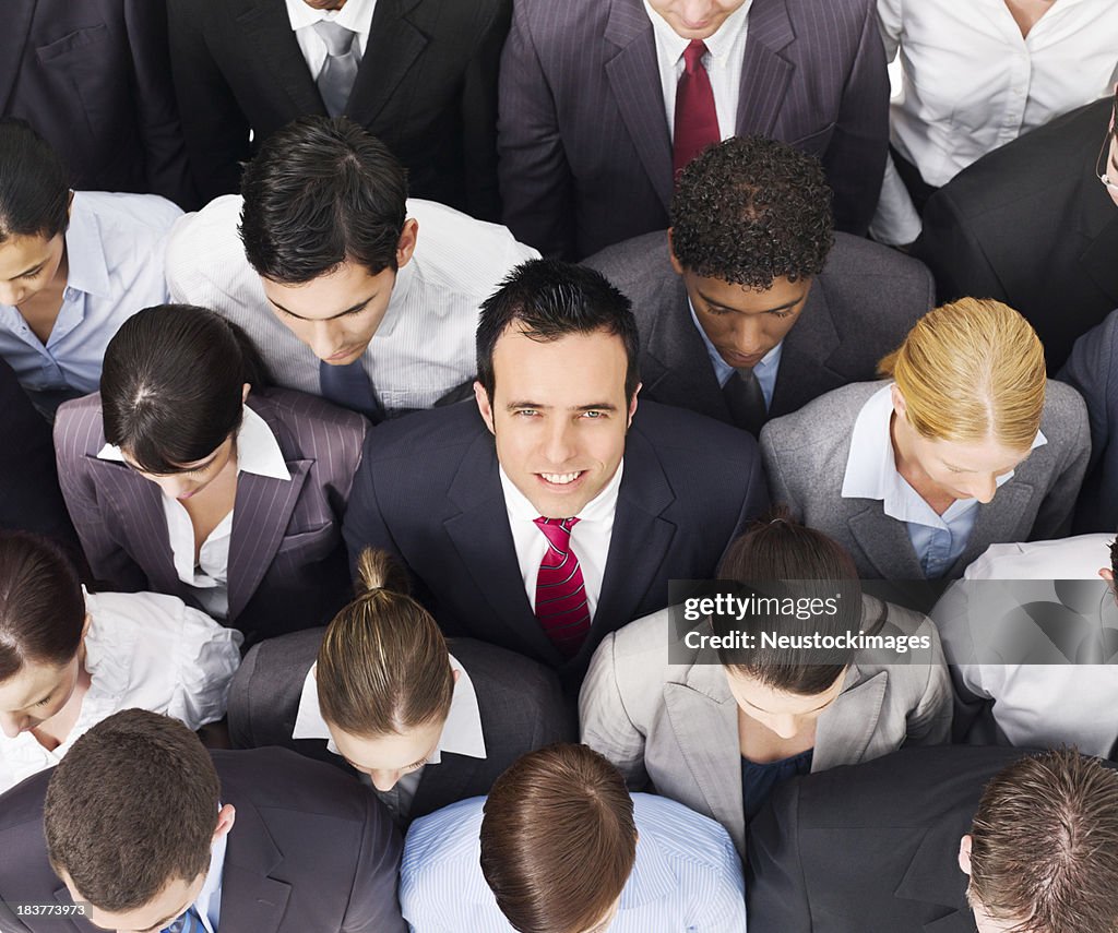 Businessman Smiling in a Crowd