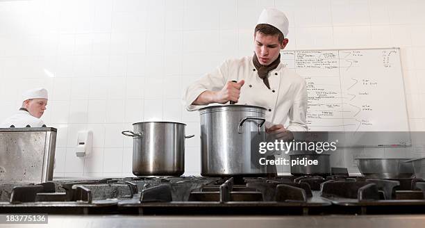 chefs cooking in restaurant kitchen - stew pot stock pictures, royalty-free photos & images
