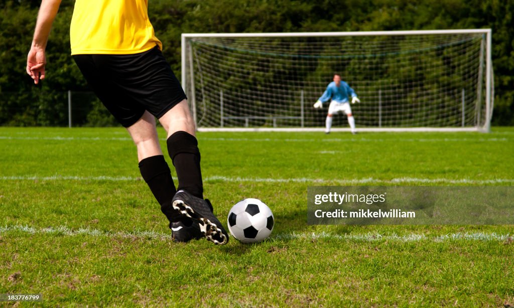 Soccer players tries to make a goal