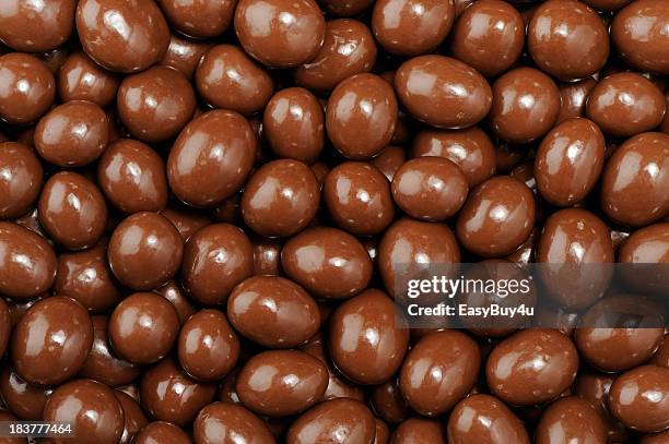 chocolate dipped peanuts pattern - pile of candy stock pictures, royalty-free photos & images