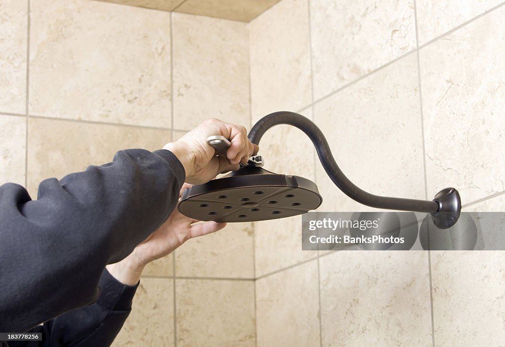 Plumber Installing Showerhead with Adjustable Wrench
